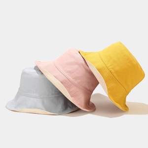 Foldable cotton bucket hats in light blue, pink and yellow with double-sided design