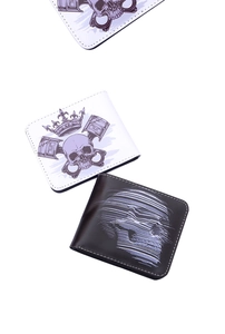 Detail of short bifold wallets with skull prints and fine white stitching on leather