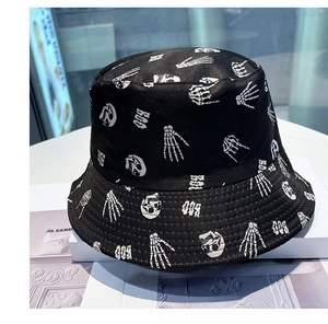Detail of black reversible bucket hat with white skull and boo graphics and reinforced stitching