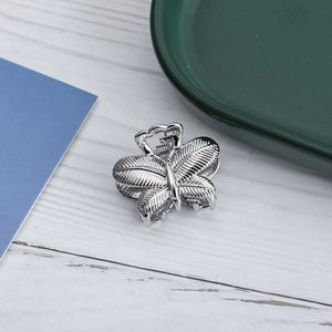 Silver butterfly hair claw clip with metallic feather texture for elegant styling