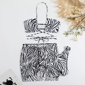 Detail of zebra print three-piece bikini set with wrap-around tie and mesh sarong
