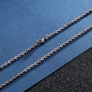 Detail of silver stainless steel cross chain with secure lobster clasp closure