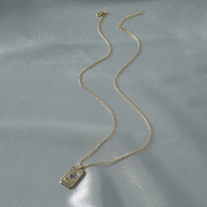 Vintage gold tarot card pendant necklace with L'AMOUR engraving on silk background