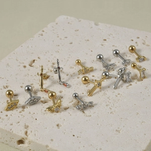 Collection of stainless steel cartilage studs with zircon wings and dagger designs