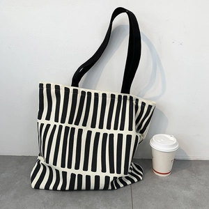 Macro detail of the classic black and white vertical striped canvas tote bag texture
