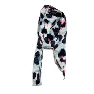 Detail of blue satin durag with pink and black leopard print on a clean white background
