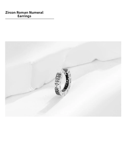 Close-up of S925 sterling silver earring featuring Roman numerals and zircon heart setting