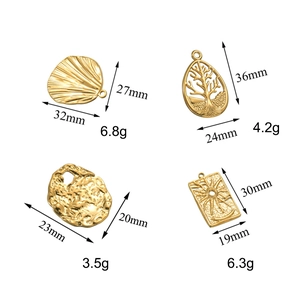 Detailed view of gold stainless steel tree of life and sun charms with size specs
