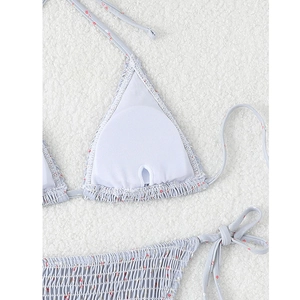 Detail of light blue floral bikini top showing inner pad pocket and textured fabric