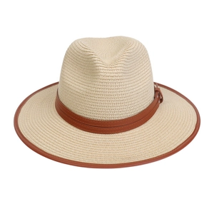 Detail of British style Panama straw hat featuring fine weave and brown leather strap buckle