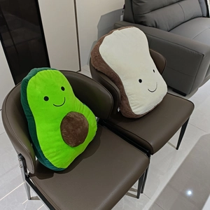 Detail of plush avocado and toast pillows showing soft short plush fabric texture