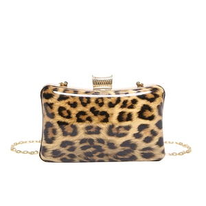 Detailed shot of leopard print acrylic evening clutch with gold metal clasp and chain