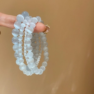 Detail of light blue cat eye stone beads in 4mm 6mm and 8mm sizes with silky luster