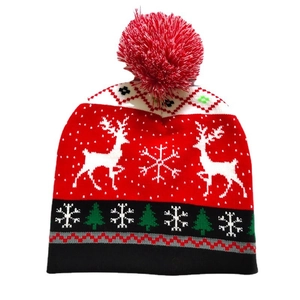 Christmas jacquard knit beanie with reindeer patterns and pompom in red and white colors
