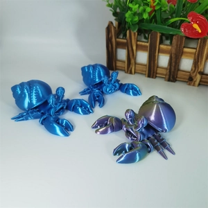 Close-up of 3D printed hermit crab models in blue and purple gradient with metallic finish