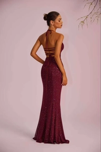 Detail of burgundy sequin evening dress featuring backless tie design and mermaid silhouette