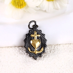 Close-up of gold plated anchor heart and cross pendant charm with zircon inlay