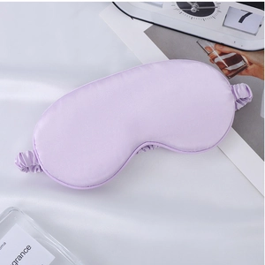 Detailed close-up of light purple silk satin sleep mask with soft elastic strap texture