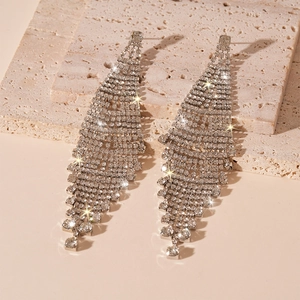 Close-up of sparkling silver tassel earrings with multiple rows of dangling rhinestones
