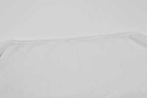 Close-up of the white ice silk knit fabric showing fine texture and neckline craftsmanship