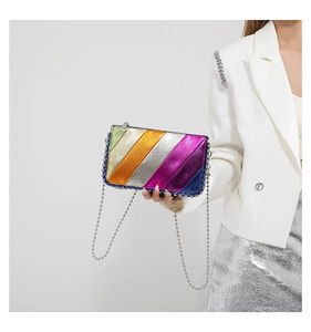Detail of metallic patchwork leather bag with colorful diagonal stripes and bead chain