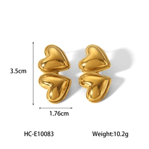 Detailed size view of gold double heart earrings measuring 3.5cm by 1.76cm