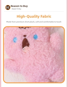 Close-up of soft pink plush fabric with detailed blue and brown embroidery on the doll