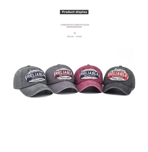 Detail of four vintage washed cotton baseball caps with distressed embroidered patches