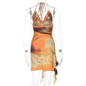 Detail showing the lace-up open back and asymmetric ruffle hem of the printed sun dress