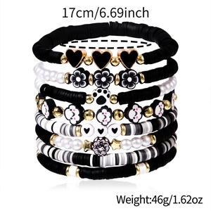 Multilayer beaded bracelet set with black and white heart flower charms in gold finish