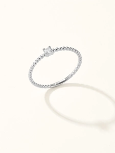 Macro shot of silver beaded ring with sparkling round zircon and S925 hallmark stamp