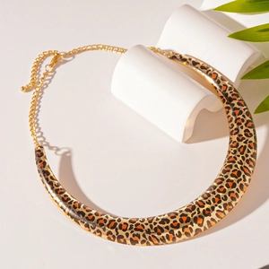 Detail of leopard print U-shaped collar necklace on a white minimalist background