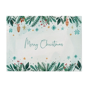 Detail of linen placemat with Merry Christmas print and festive botanical patterns