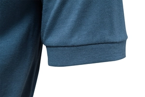 Detailed macro view of the ribbed cuffs on a blue knitted cotton T-shirt with fine texture