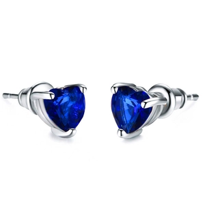 Macro shot of silver stud earrings featuring heart-shaped blue zircon in a three-prong setting