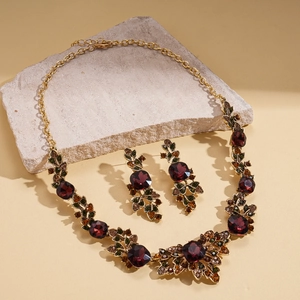 Vintage gold necklace and earring set with wine red stones and floral leaf designs