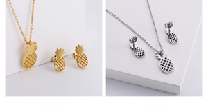 Detail of gold and silver pineapple jewelry set showing vacuum plating craftsmanship