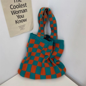 Detail of knit checkerboard tote bag in orange and teal with soft ribbed texture