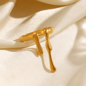 Minimalist irregular lava style open ring in gold finish on champagne silk background