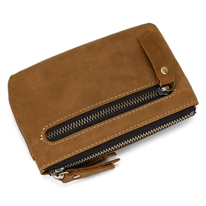 Detailed view of genuine brown leather coin purse with vintage texture and zipper pocket