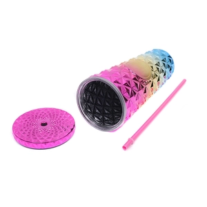 Detail view of rainbow gradient studded tumbler with geometric texture and matching straw