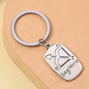 Detail of silver alloy keychain featuring engraved Sagittarius bow icon and text