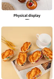 Detailed view of artificial PU croissants and cupcakes arranged on a wooden tray with props