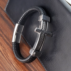 Retro men's woven leather bracelet featuring a silver metallic cross with feather texture