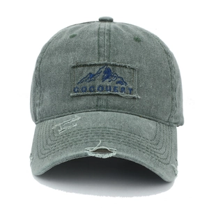 Detailed view of army green distressed washed cotton baseball cap with mountain patch