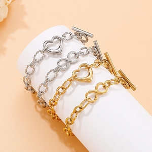Set of gold and silver stainless steel heart and infinity link bracelets with toggle clasp