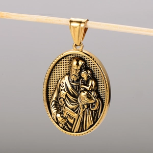 Macro detail of oval 18k gold plated stainless steel religious portrait pendant