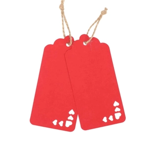 Red heart-shaped cutout kraft paper gift tags with jute twine for Valentine parties