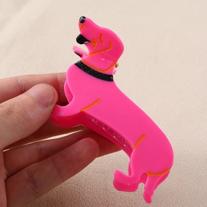 Detailed view of a pink dachshund hair claw clip with colorful collar details