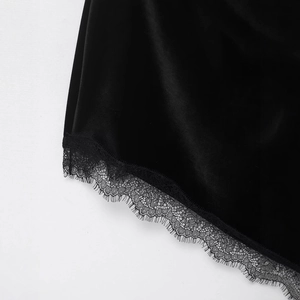 Slim fit black velvet dress with delicate lace trim featuring an asymmetrical hemline